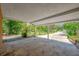 Open carport space provides views of the backyard and surrounding greenery at 6104 Palm Ave, Gibsonton, FL 33534