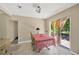 Sunny dining area features tile flooring, sliding glass doors, and checkered tablecloth at 6104 Palm Ave, Gibsonton, FL 33534