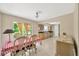 Light-filled dining area with tile floors that connect to a kitchen with wood cabinets at 6104 Palm Ave, Gibsonton, FL 33534