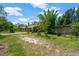 Exterior yard view with lush trees and foliage surrounding home at 6104 Palm Ave, Gibsonton, FL 33534