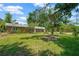 Charming brick home with a well-manicured lawn and mature trees, offering a serene and inviting setting at 6104 Palm Ave, Gibsonton, FL 33534