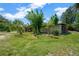 Exterior yard view with tropical landscaping surrounding this home at 6104 Palm Ave, Gibsonton, FL 33534