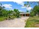 Charming single-story home with a driveway leading to the carport at 6104 Palm Ave, Gibsonton, FL 33534