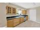 The kitchen has wood cabinets, granite countertops and stainless steel appliances at 6104 Palm Ave, Gibsonton, FL 33534