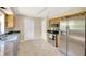 This kitchen features tile floors, stainless appliances, granite countertops, and light wood cabinets at 6104 Palm Ave, Gibsonton, FL 33534