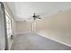 Spacious living room features carpeted floors, neutral walls, and lots of natural light at 6104 Palm Ave, Gibsonton, FL 33534