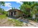 Exterior view of metal outbuilding surrounded by lush vegetation at 6104 Palm Ave, Gibsonton, FL 33534
