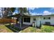 The backyard features a covered patio and lush green space at 6825 Hammock Rd, Port Richey, FL 34668