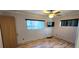 Bedroom featuring wood laminate flooring, a ceiling fan, and natural lighting at 6825 Hammock Rd, Port Richey, FL 34668