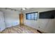 Well-lit bedroom featuring laminate flooring, a ceiling fan, and a built in closet at 6825 Hammock Rd, Port Richey, FL 34668