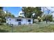 Nice single-story home with neat landscaping, an airy exterior paint scheme, and a fenced yard at 6825 Hammock Rd, Port Richey, FL 34668