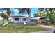 Charming single-story home with a carport, a fenced yard, and mature trees, nestled in a quiet neighborhood at 6825 Hammock Rd, Port Richey, FL 34668