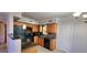 Well-equipped kitchen boasting wooden cabinets, black appliances, and tile flooring at 6825 Hammock Rd, Port Richey, FL 34668