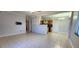 Bright living room featuring tile flooring, an open layout, and neutral paint at 6825 Hammock Rd, Port Richey, FL 34668