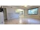 Spacious living room features tile floors and access to the kitchen and other rooms at 6825 Hammock Rd, Port Richey, FL 34668