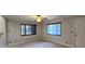 Bright living room with tile floors, ceiling fan, and lots of natural light at 6825 Hammock Rd, Port Richey, FL 34668