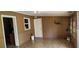 View of the mud room featuring tile flooring, access to the kitchen, and a white door at 6825 Hammock Rd, Port Richey, FL 34668