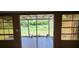The sunroom features tile flooring and sliding glass doors that offer a view of the backyard at 6825 Hammock Rd, Port Richey, FL 34668