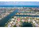 Expansive aerial view of waterfront homes with boat docks along canals leading to the ocean at 710 116Th Ave, Treasure Island, FL 33706