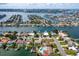 Aerial view of waterfront community with private docks and canal access at 710 116Th Ave, Treasure Island, FL 33706