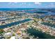 Aerial view of a home on a waterfront with canals and nearby ocean at 710 116Th Ave, Treasure Island, FL 33706