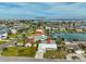 Aerial view of a waterfront home near the Gulf of Mexico, surrounded by other houses and canals at 710 116Th Ave, Treasure Island, FL 33706