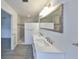 Stylish bathroom features a double vanity, large mirror, and a separate shower with marble-like tile at 710 116Th Ave, Treasure Island, FL 33706