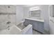 Bathroom featuring a double sink vanity, marble countertops, and a tiled shower/tub combo at 710 116Th Ave, Treasure Island, FL 33706