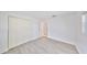 A bright bedroom featuring wood-look floors, bright white walls, and a closet at 710 116Th Ave, Treasure Island, FL 33706