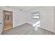 Bedroom with light gray plank flooring, white walls, and a view of the adjacent room at 710 116Th Ave, Treasure Island, FL 33706