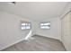 Bright bedroom featuring updated flooring and ample natural light from two windows at 710 116Th Ave, Treasure Island, FL 33706