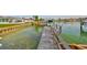 Waterfront property features a private dock with boat lift and access to open water at 710 116Th Ave, Treasure Island, FL 33706