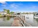 Private dock featuring a boat lift, canal access, and waterfront views at 710 116Th Ave, Treasure Island, FL 33706