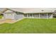 Charming single-story home featuring a well-manicured lawn and attached two-car garage with a white roof at 710 116Th Ave, Treasure Island, FL 33706