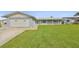 Lovely one-story home with a well-maintained lawn, attached garage, and white roof at 710 116Th Ave, Treasure Island, FL 33706