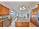 Spacious kitchen featuring wood cabinets, stainless steel appliances, granite countertops, and a large island at 710 116Th Ave, Treasure Island, FL 33706