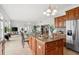 Bright kitchen boasts wood cabinets, stainless steel appliances, and a large island with granite countertops at 710 116Th Ave, Treasure Island, FL 33706