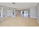 Spacious living area with tile floors, neutral gray walls, and an open layout to other rooms at 710 116Th Ave, Treasure Island, FL 33706