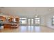 Spacious living room with tile floors, bright white walls, leading to a modern kitchen with wood cabinets at 710 116Th Ave, Treasure Island, FL 33706