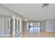 Open living area with tile floors, bright light gray walls and decorative support beams at 710 116Th Ave, Treasure Island, FL 33706