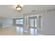 Open-concept living space with tile floors, neutral walls, and decorative light fixtures at 710 116Th Ave, Treasure Island, FL 33706