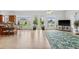 Bright living room with tile floors, light walls, glass doors, and views of the landscaped backyard at 710 116Th Ave, Treasure Island, FL 33706