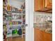 Walk-in pantry with wire shelving provides ample storage in kitchen area at 710 116Th Ave, Treasure Island, FL 33706