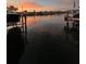 Beautiful waterfront sunset featuring boat lifts and waterfront community at 710 116Th Ave, Treasure Island, FL 33706