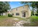Exterior back of house featuring a backyard, patio and sliding doors leading inside at 7249 Bridgeview Dr, Wesley Chapel, FL 33545
