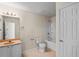 Bathroom featuring a single vanity, shower-tub combo, and a door at 7249 Bridgeview Dr, Wesley Chapel, FL 33545