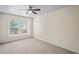 Comfortable bedroom with neutral walls and carpet featuring a ceiling fan and a window at 7249 Bridgeview Dr, Wesley Chapel, FL 33545