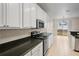 Kitchen featuring granite countertops, stainless steel appliances, and tiled flooring at 7249 Bridgeview Dr, Wesley Chapel, FL 33545