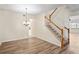 Open-concept living room featuring hardwood floors, staircase and ample natural light at 7249 Bridgeview Dr, Wesley Chapel, FL 33545