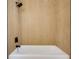 Modern bathtub featuring sleek black hardware and fixtures, complemented by neutral tiled walls at 7500 16Th N St, St Petersburg, FL 33702